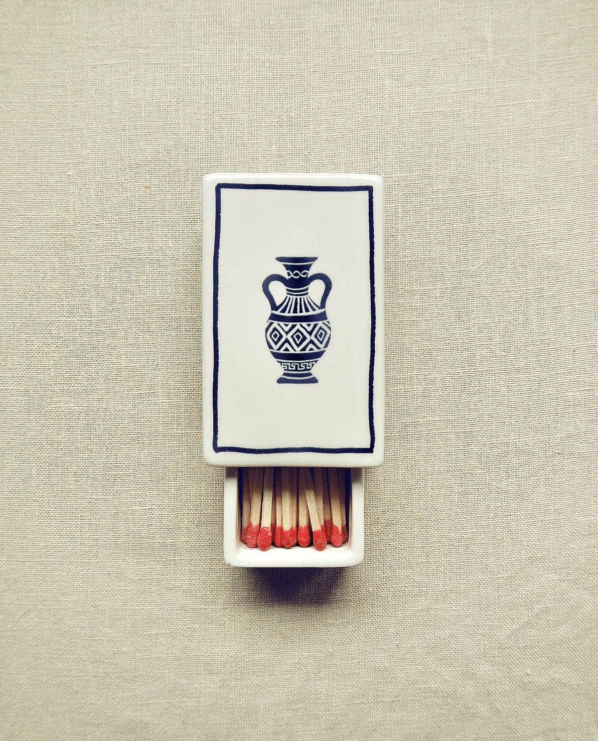 Hand-illustrated ceramic matchbox with amphora illustration