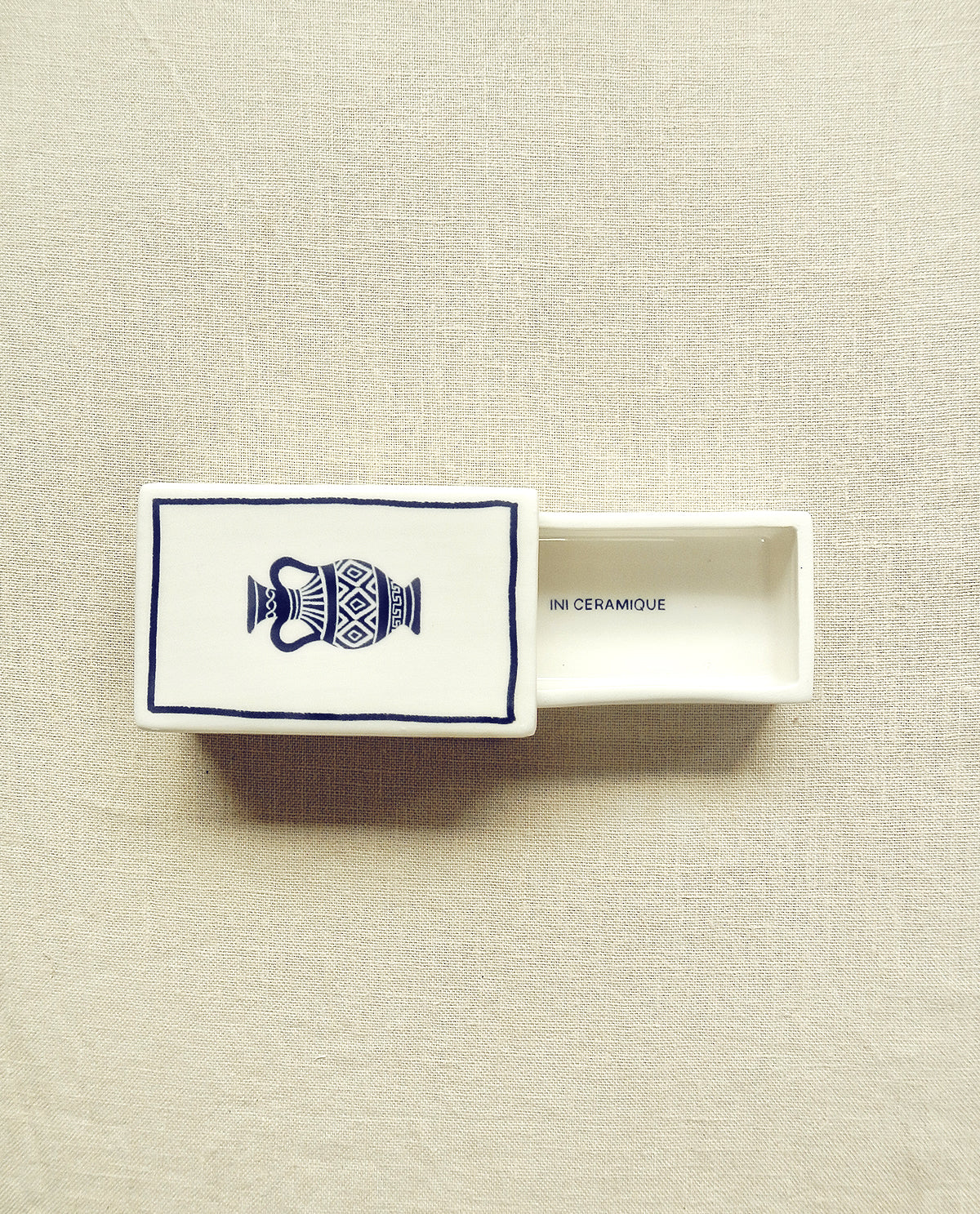 Hand-illustrated ceramic matchbox with amphora illustration