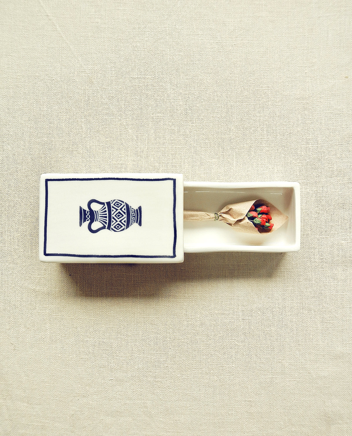 Hand-illustrated ceramic matchbox with amphora illustration