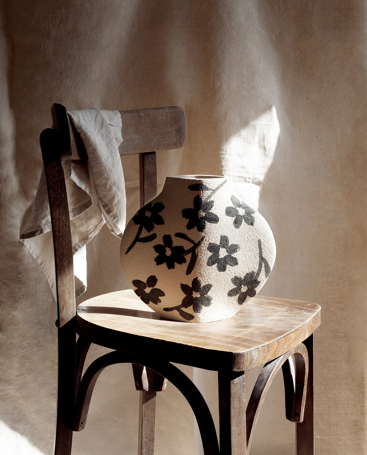 Hand-painted floral vase by INI CERAMIQUE with flowers patterns and textured finish