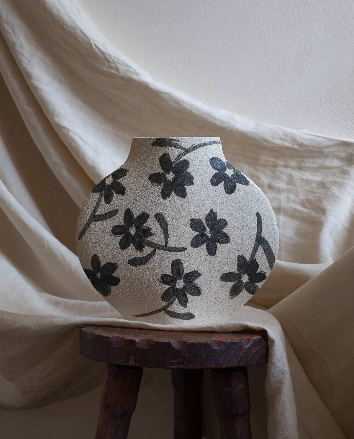Hand-painted floral vase by INI CERAMIQUE with flowers patterns and textured finish