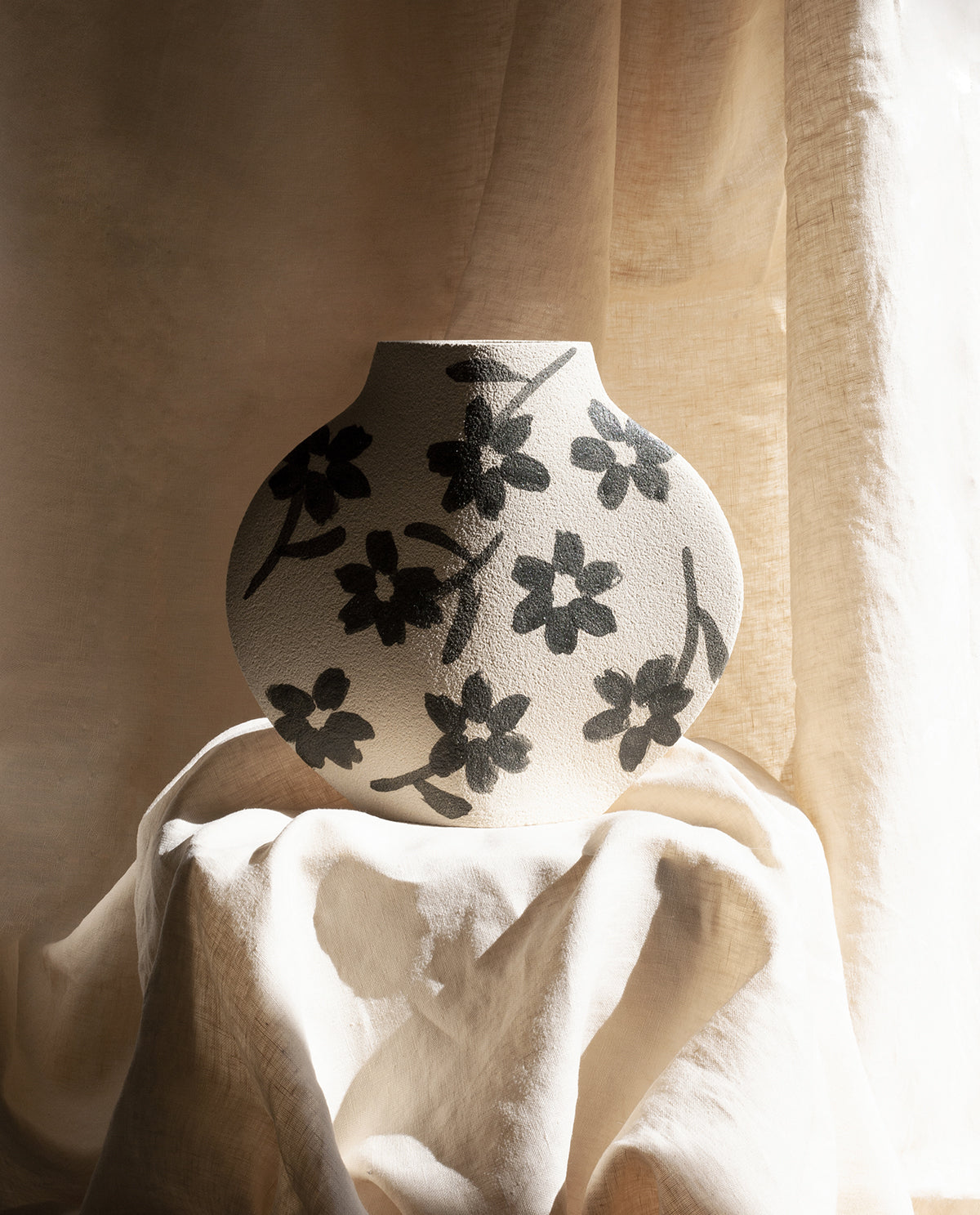 Hand-painted floral vase by INI CERAMIQUE with flowers patterns and textured finish