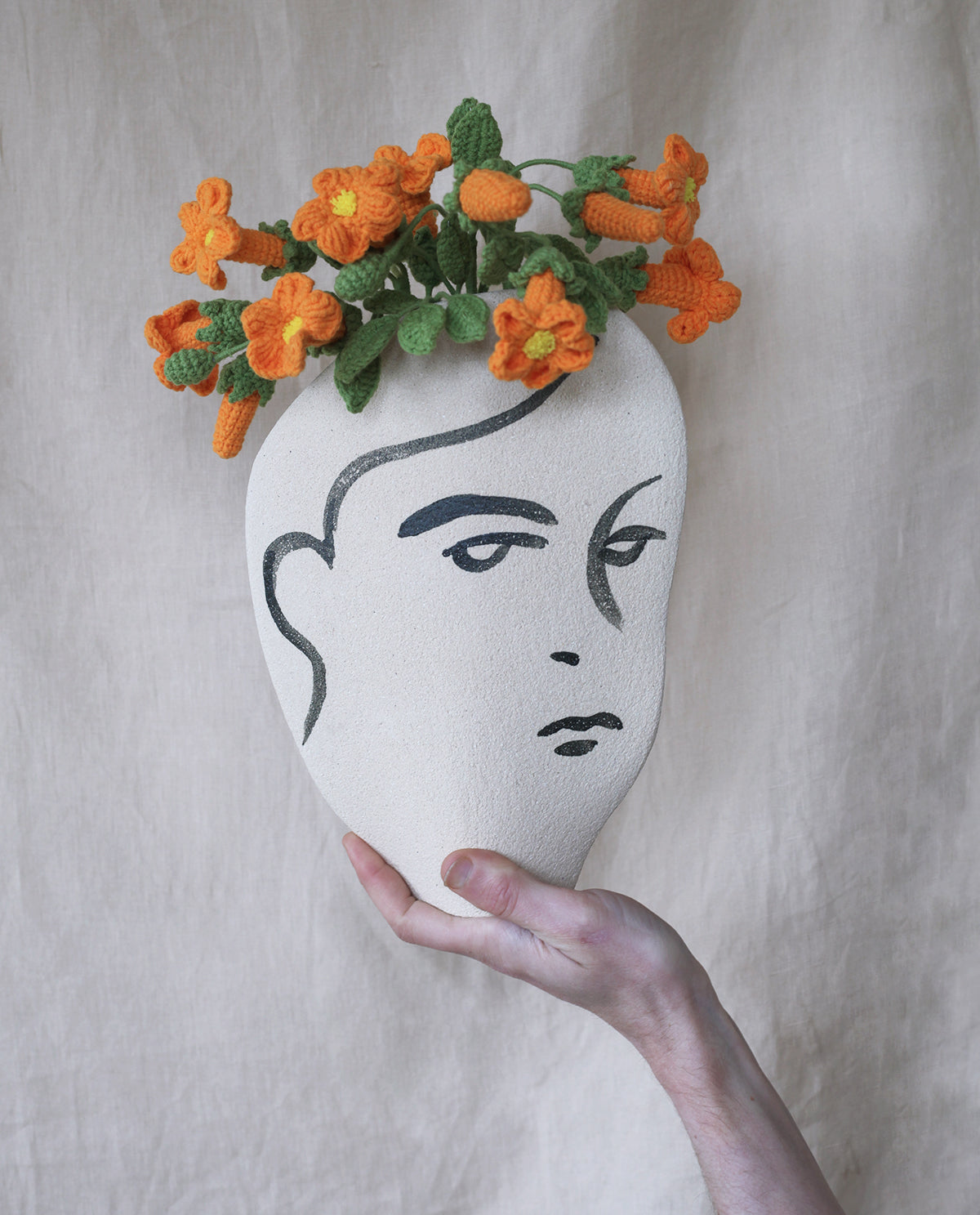 Hand-painted face vase by INI CERAMIQUE with illustrative patterns and a textured finish