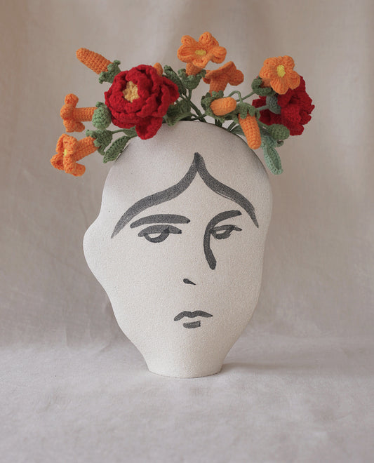 Hand-painted face vase by INI CERAMIQUE with illustrative patterns and a textured finish