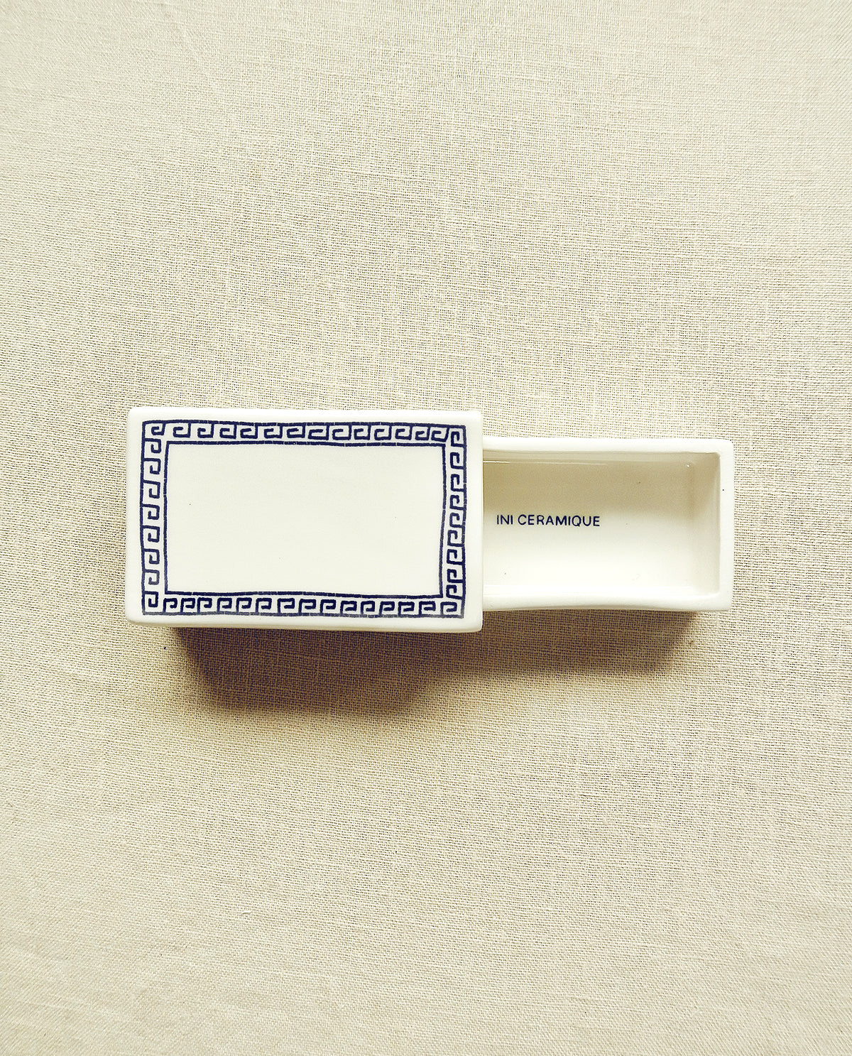 Hand-illustrated ceramic matchbox with Greek pattern design