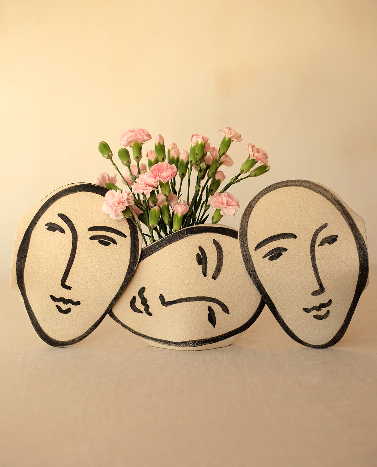 ‘Matisse Face’ Vase - Handmade Stoneware
Inspired by Matisse, this handcrafted stoneware vase features black underglaze motifs on a raw, textured surface. Fired at 1250°C with a transparent glazed interior, each piece is unique, with subtle variations in shape and color.