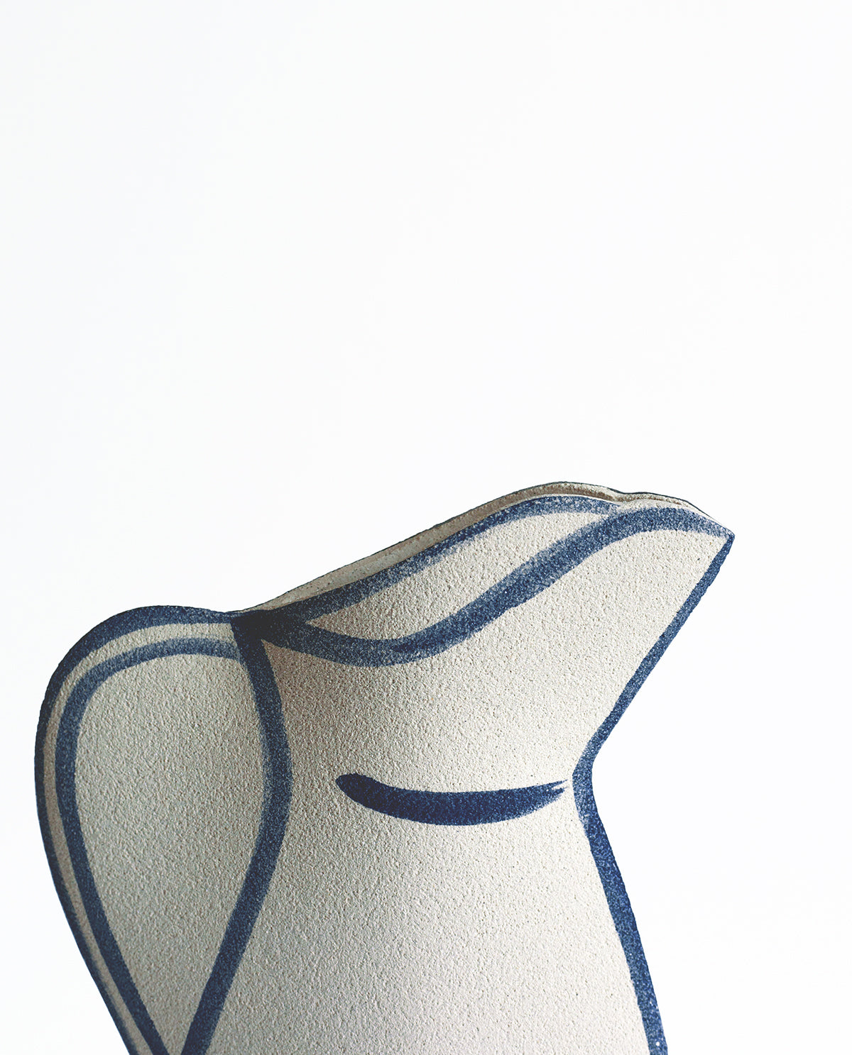 Hand-painted trompe l'oeil vase by INI CERAMIQUE with illustrative patterns and a textured finish