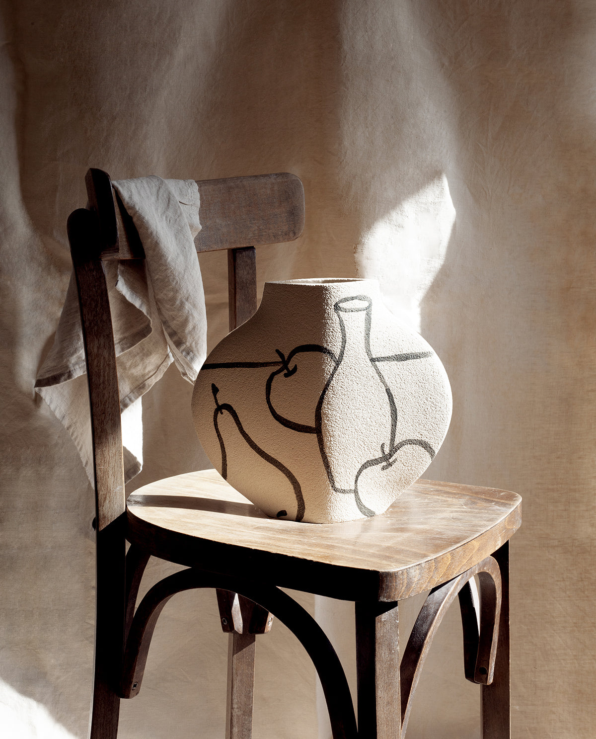 Hand-painted trompe l'oeil vase by INI CERAMIQUE with illustrative patterns and a textured finish