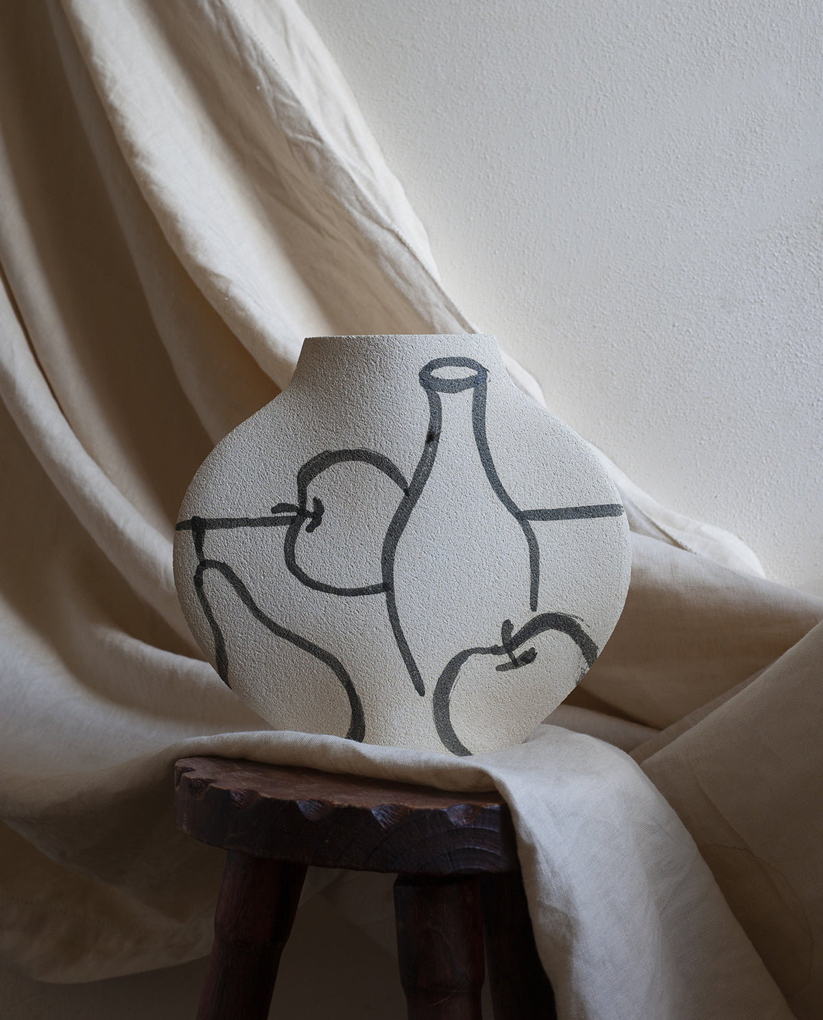 Hand-painted trompe l'oeil vase by INI CERAMIQUE with illustrative patterns and a textured finish