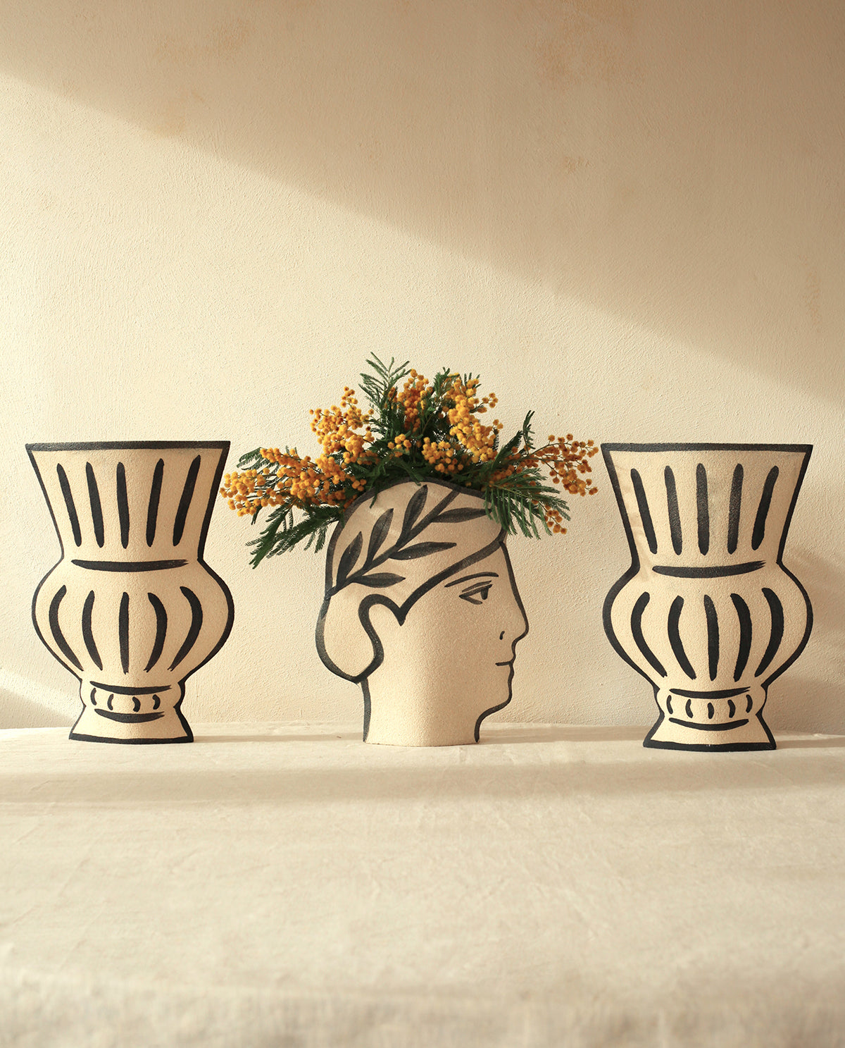 Hand-painted greek vase by INI CERAMIQUE with face patterns and a textured finish