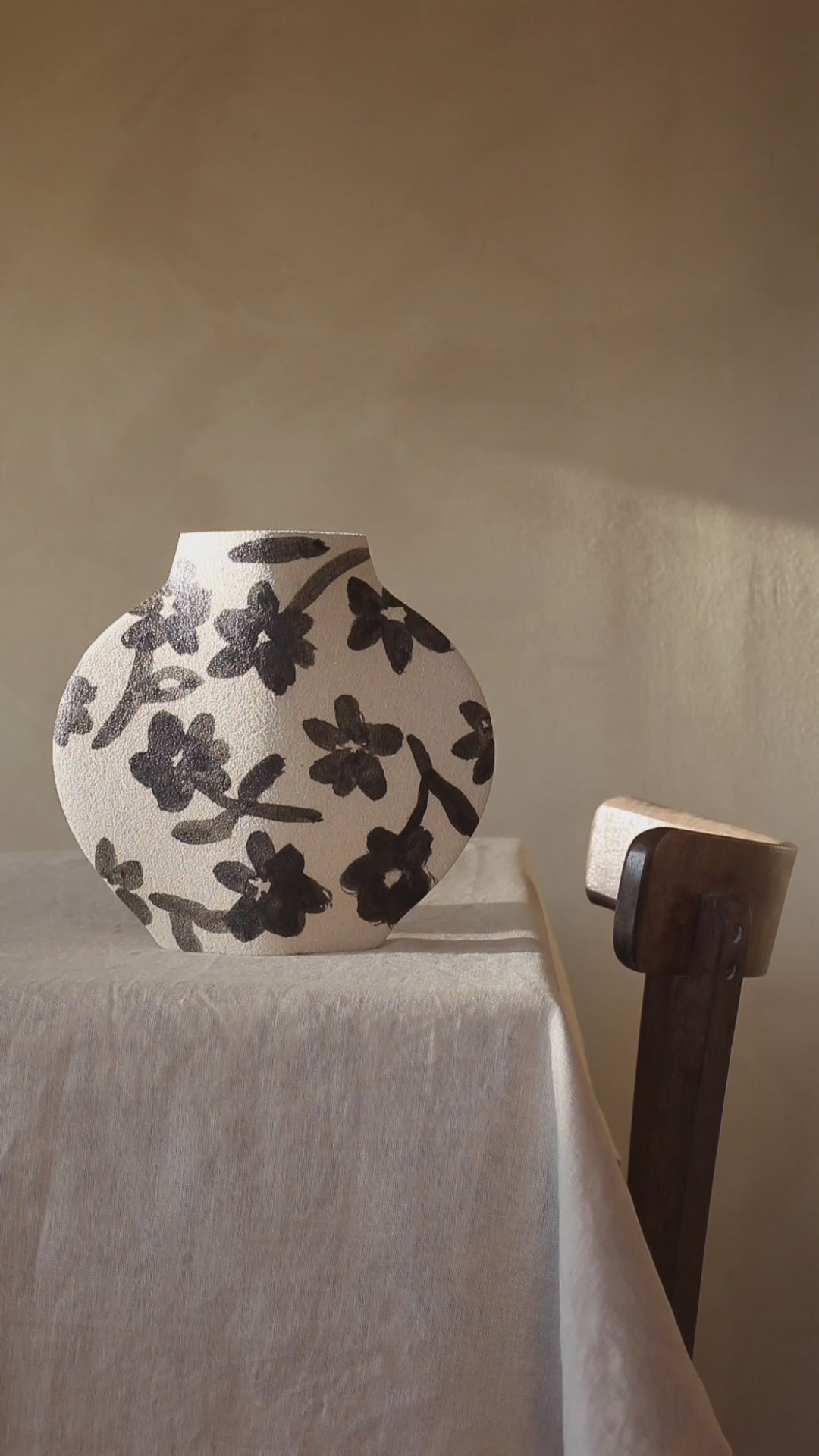 Hand-painted floral vase by INI CERAMIQUE with flowers patterns and textured finish