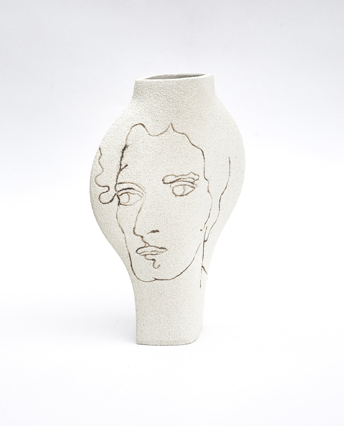 Hand-painted face vase by INI CERAMIQUE with carved portrait patterns and textured finish