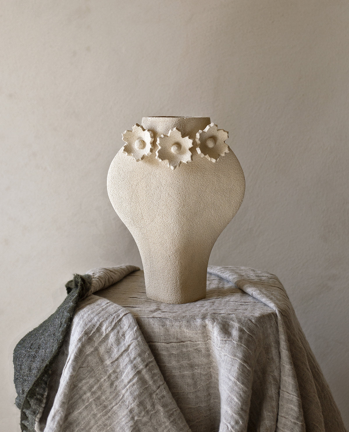 Handmade floral vase by INI CERAMIQUE with flower sculptures and textured finish