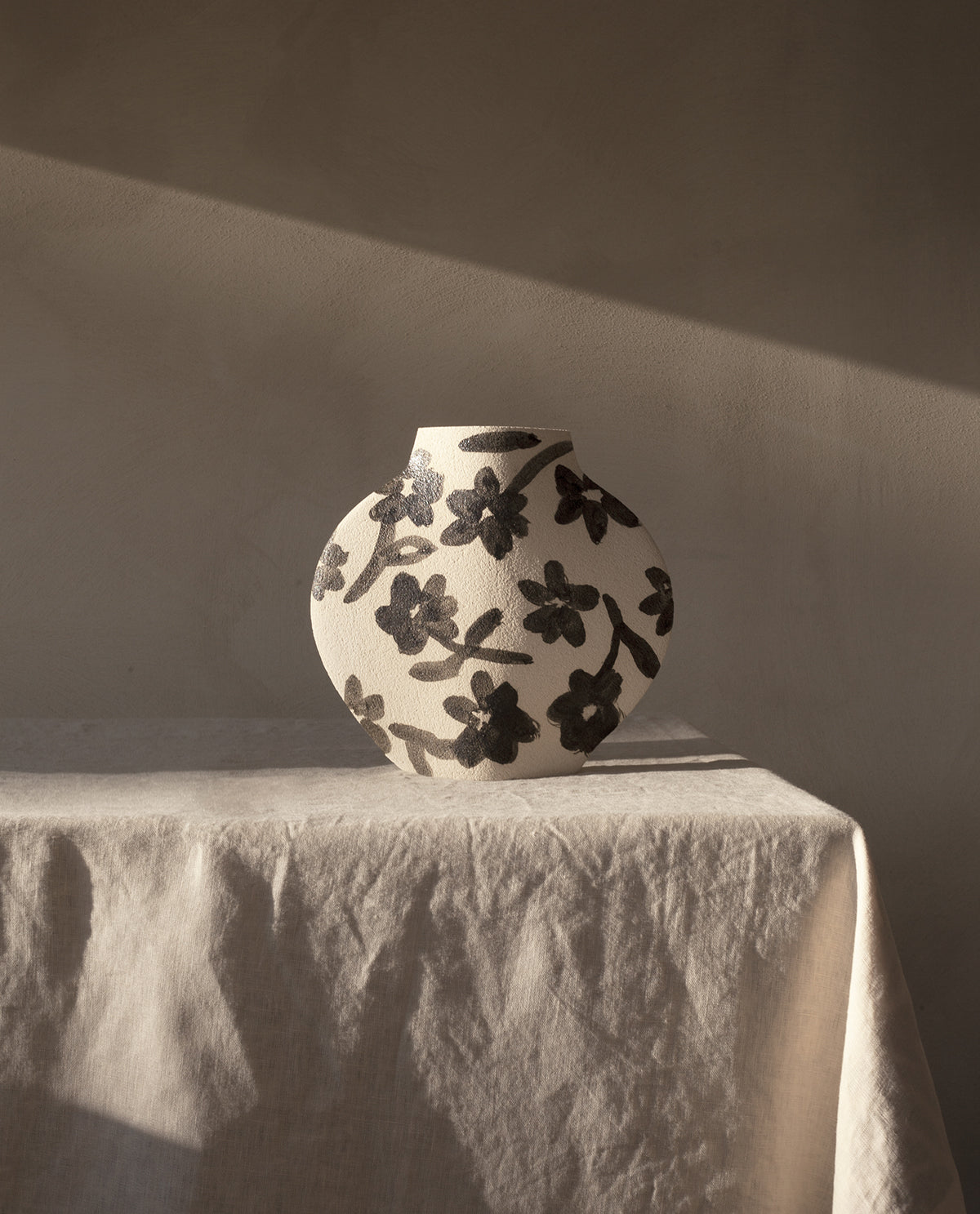 Hand-painted floral vase by INI CERAMIQUE with flowers patterns and textured finish