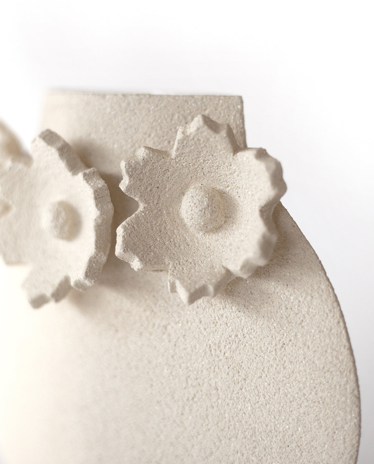 Handmade floral vase by INI CERAMIQUE with flower sculptures and textured finish