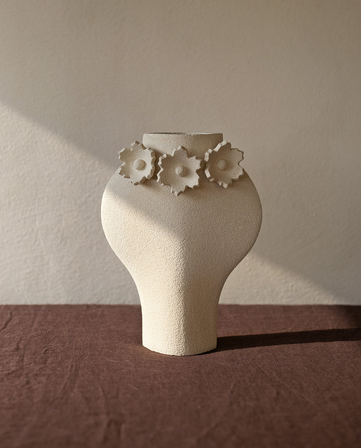 Handmade floral vase by INI CERAMIQUE with flower sculptures and textured finish