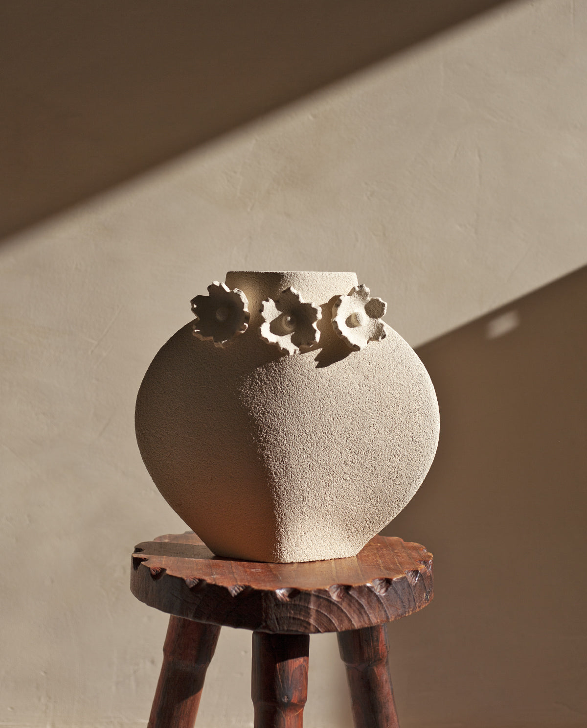 Handmade floral vase by INI CERAMIQUE with flower sculptures and textured finish