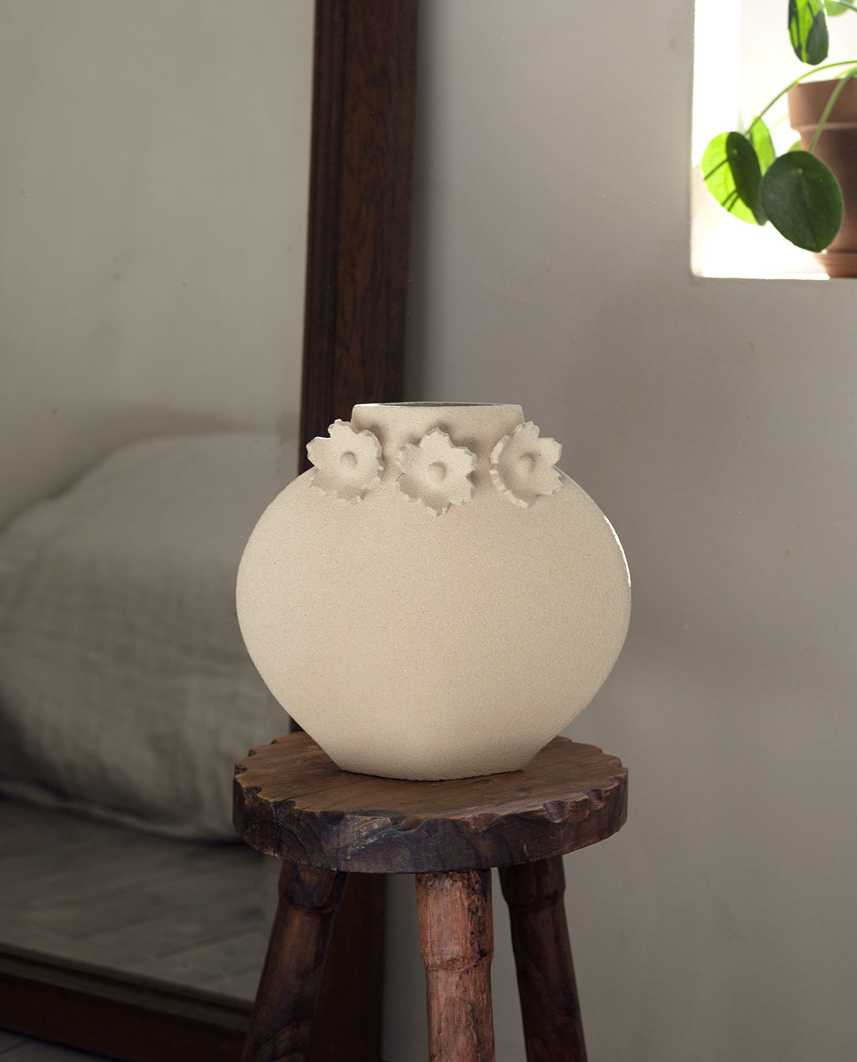 Handmade floral vase by INI CERAMIQUE with flower sculptures and textured finish