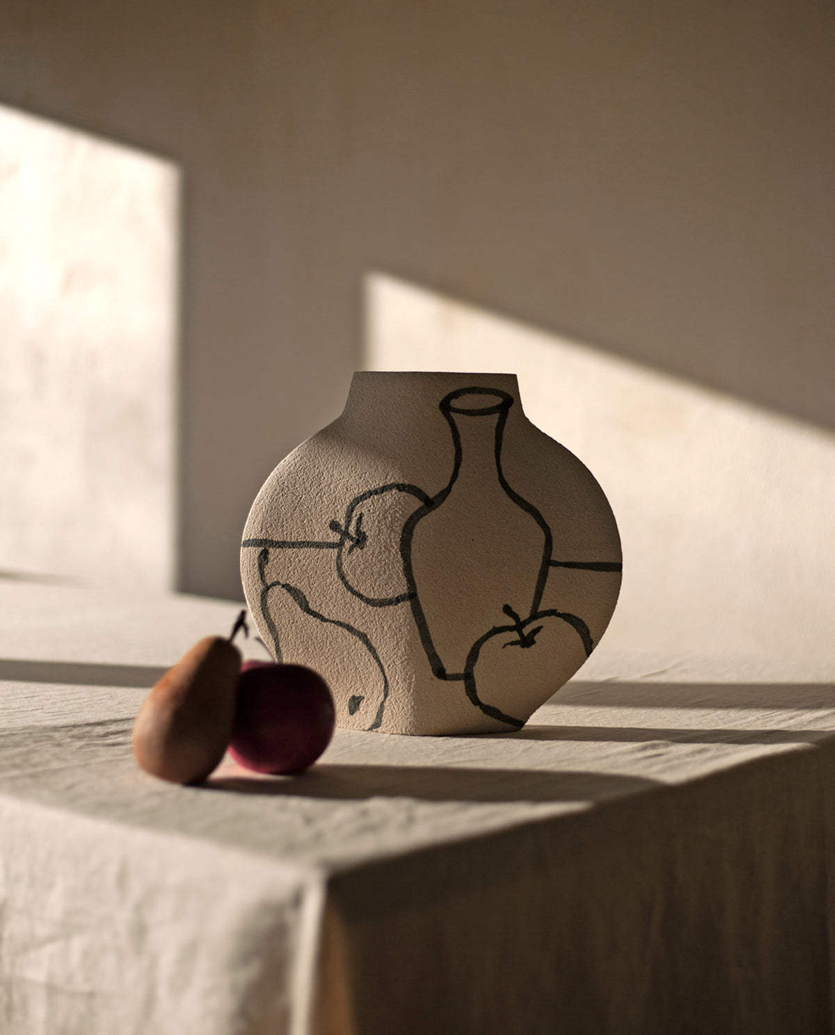 Hand-painted trompe l'oeil vase by INI CERAMIQUE with illustrative patterns and a textured finish