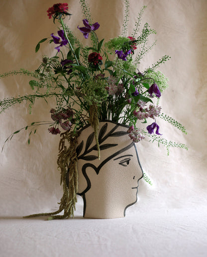 Hand-painted greek vase by INI CERAMIQUE with face patterns and a textured finish