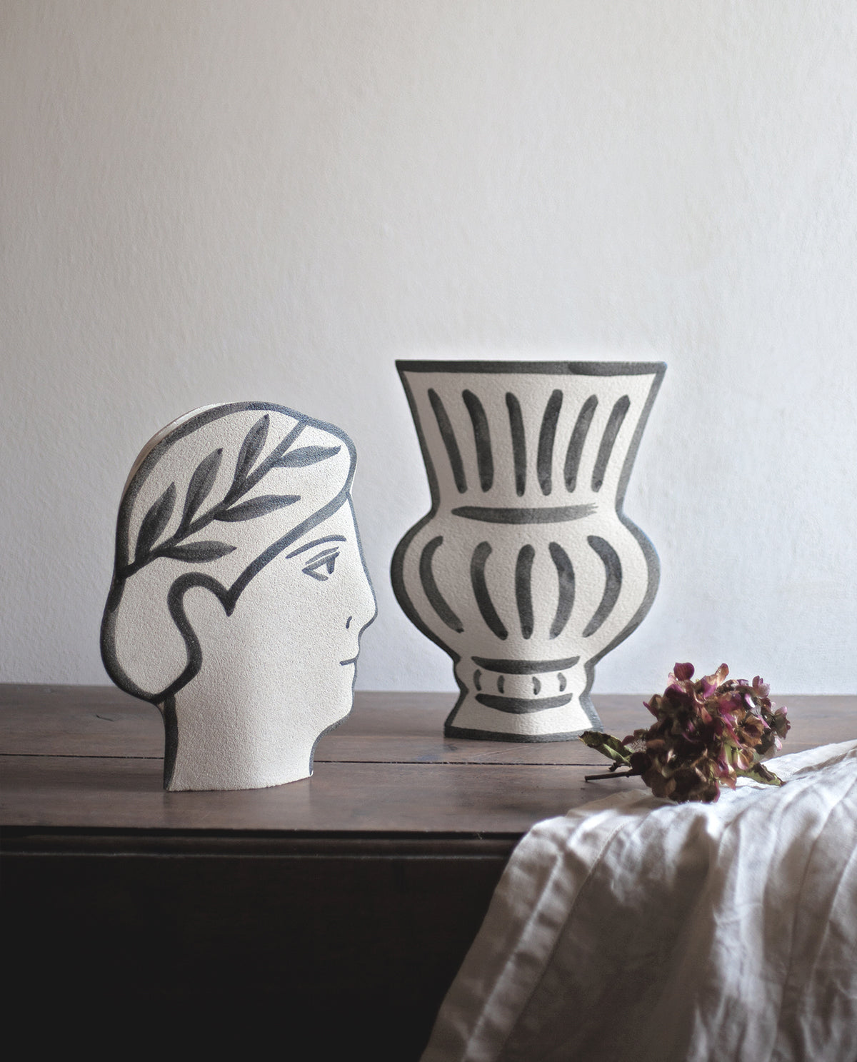 Hand-painted greek vase by INI CERAMIQUE with face patterns and a textured finish