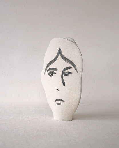 Hand-painted face vase by INI CERAMIQUE with illustrative patterns and a textured finish