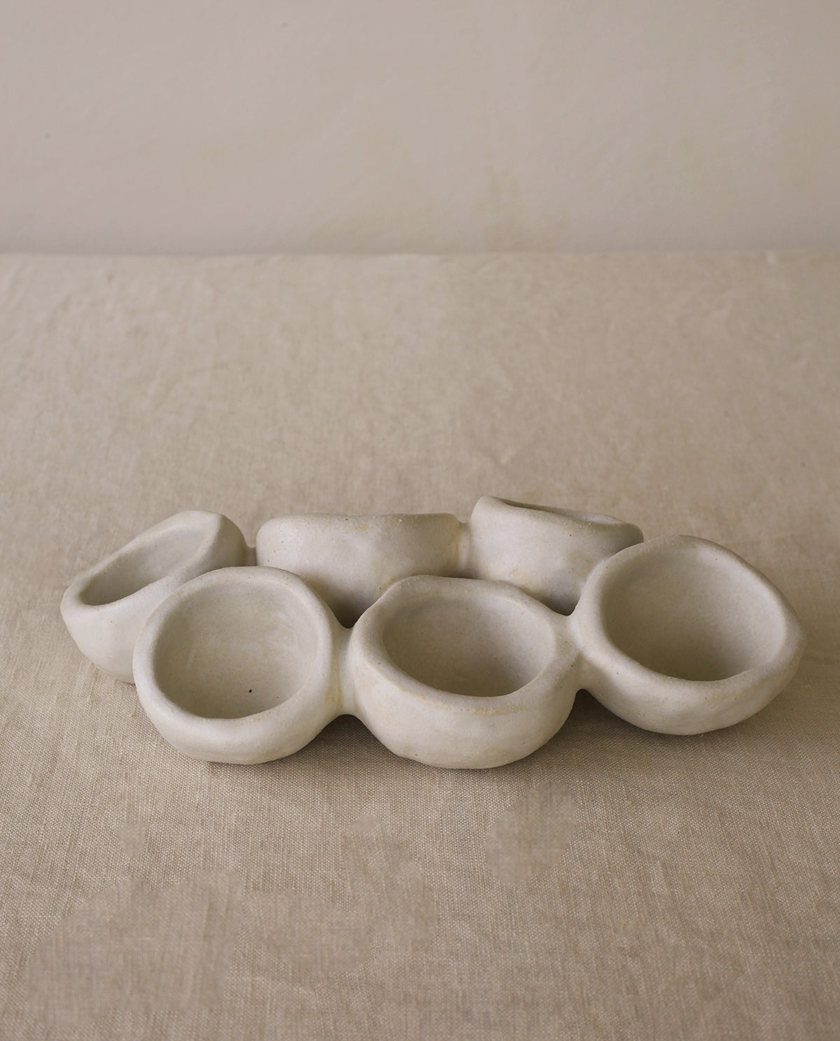 Handmade ceramic plate by INI CERAMIQUE featuring an original organic design and matte cream finish