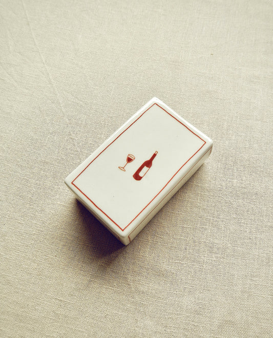 Hand-illustrated ceramic matchbox with wine bottle and glass illustration