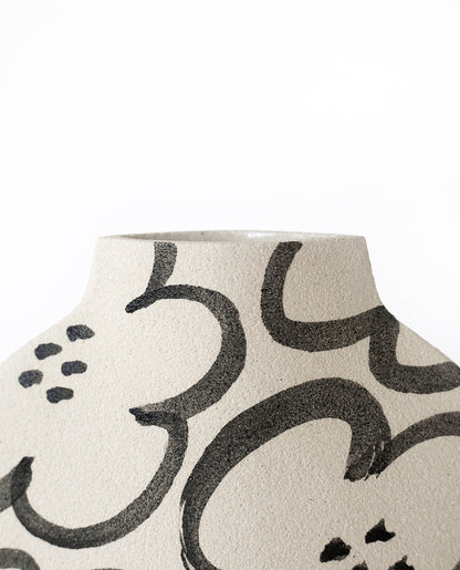 Hand-painted floral vase by INI CERAMIQUE with camellia patterns and a textured finish